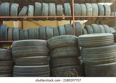 Old Car Tires Under The Roof. Warehouse Of An Old Tire Garage. Used Car Tires