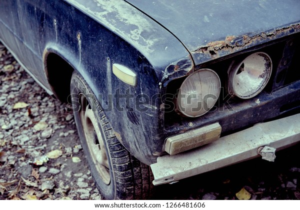 Old car, trail rust,\
headlights closeup