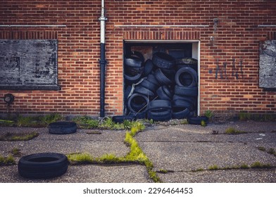 Old  car tyres in a factory doorway