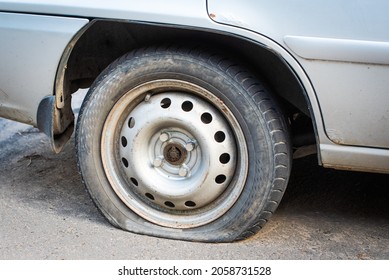 old car wheel. flat tire. an accident has occurred and assistance is required. dirty rubber tire