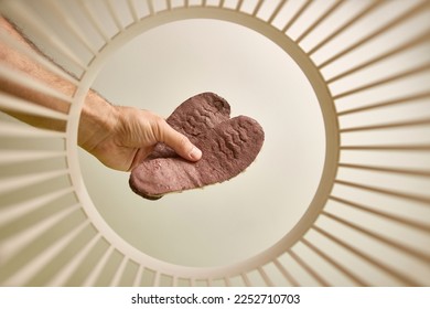 Old cardboard wool insoles are thrown into the trash for disposal and recycling. View from below. The concept of utilization and processing of waste.
