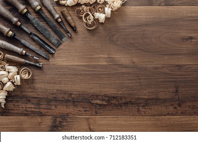 Old carpentry tools on a workbench and blank copyspace: woodworking, craftsmanship and handwork concept, flat lay
