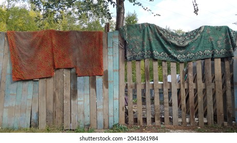 Old Carpets Are Hanging On The Fence