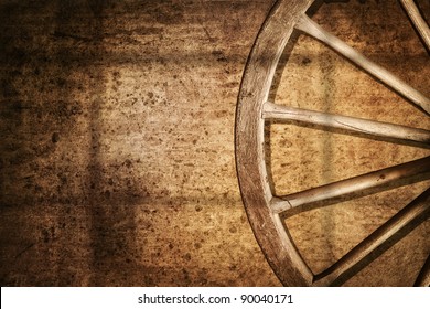 Old cart wheel against wall