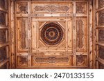 old carved wooden ceiling with oriental pattern Uzbek ornament in the Museum of Victims of Political Repression in Tashkent in Uzbekistan close-up
