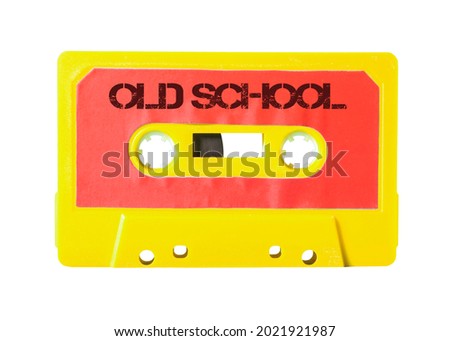 An old cassette tape (analog storage media for music) with the text Old School. Electric flamboyant colors.
