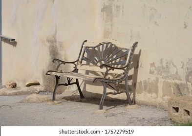 Old Cast Iron Bench In Hot Scorching Sun