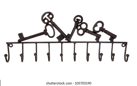 Old cast iron key holder rack over white background.