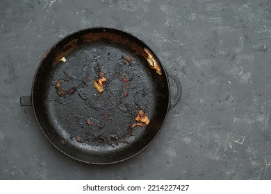 Old Cast Iron Pan With Burnt Food. Carcinogen