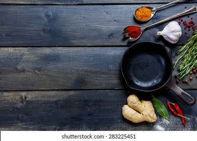 Old Cast Iron Skillet And Ingredients On Rustic Wooden Background. Vegetarian Food, Health Or Cooking Concept.