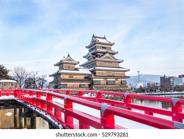 Old castle in japan. Matsumoto castle against blue sky in Nagono city,Japan.Castle in Winter with heavy snowfall.Travel Matsumoto Castle with frozen pond in Winter.Japanese and East Asian Civilization