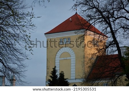 An old castle at sunset, tower close-up. Ventspils, Latvia. Travel destinations, landmarks, sightseeing, culture and religion, history, past, architecture themes