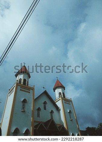 old cathedral church, dark clouds, blue sky