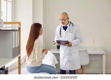 Old Caucasian male doctor in medical uniform consult female client at hospital appointment. Mature man GP have consultation or checkup with woman patient in clinic. Healthcare concept. - Powered by Shutterstock