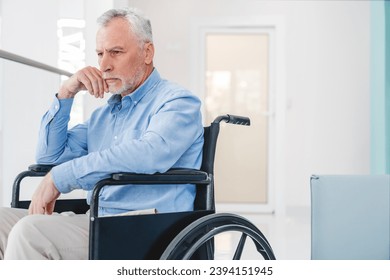 Old caucasian man sitting on wheelchair feeling lonely and depress indoors.  senior patient left alone in hospice. No support. - Powered by Shutterstock