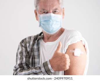 Old caucasian senior man wearing mask prevents covid coronavirus infection by vaccination. - Powered by Shutterstock