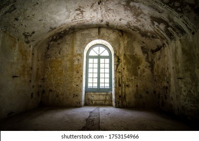 An old cell with a window in an ancient fortress.