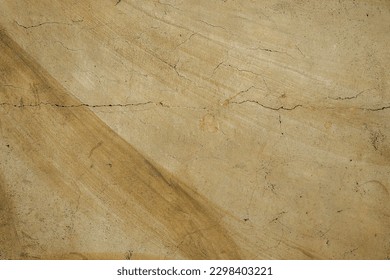 Old cement fresco painted in soft brownish-grey tones with visible cracks and textured surface, resembling a worn-out antique artwork. Perfect for man-made background images.