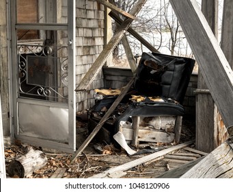 Old Chair Broken Screen Door And Collapsing Wood On An Old Porch