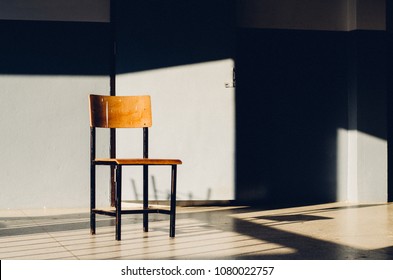 An Old Chair In Front Of A Classroom Door