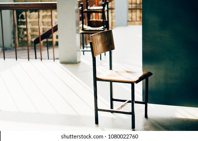 An Old Chair In Front Of A Classroom Door