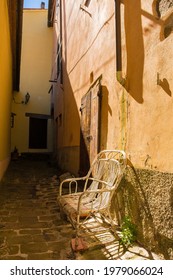 An Old Chair Outside A Residential Building In The Historic Medieval Village Of Scansano, Grosseto Province, Tuscany, Italy
