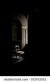 Old Chair Standing In A Dark Room Near The Window, On The Old Floor Beside An Empty Locker.