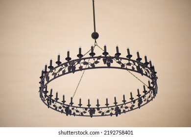 An Old Chandelier With Candles On The Ceiling