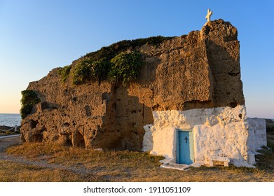 Old Chapel Built Inside A Big Rock At A Beach Of Skyros Island In Greece At Sunset