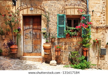 Similar – Image, Stock Photo A Mediterranean courtyard, the curved facade of a residential building and a delicate flower