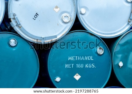 Old chemical barrels. Stack of blue methanol or methyl alcohol drum. Steel chemical tank. Toxic waste. Chemical barrel with toxic warning symbol. Industrial waste in drum. Hazard waste storage.