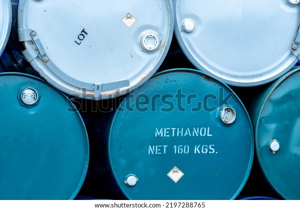 Old chemical barrels. Stack of blue methanol or\
methyl alcohol drum. Steel chemical tank. Toxic waste. Chemical\
barrel with toxic warning symbol. Industrial waste in drum. Hazard\
waste storage.