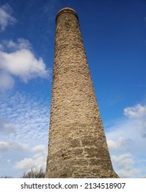 Old chimney at Troopers Hill in Bristol against a blue and cloudy sky - Shutterstock ID 2134518907