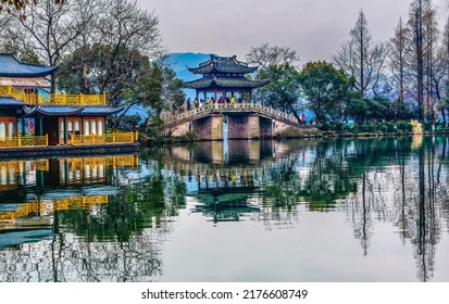 Old Chinese Bridge Quyuan Garden Yellow Boat West Lake Hangzhou Reflection Zhejiang Province China .  - Shutterstock ID 2176608749
