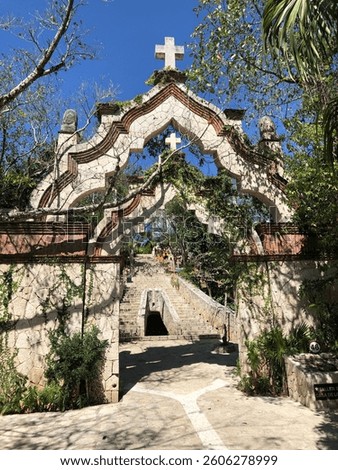 Old Christian gate to a garden or cemetery - Catholic influence in Central America or Mexico - beautiful nature growing on wall 