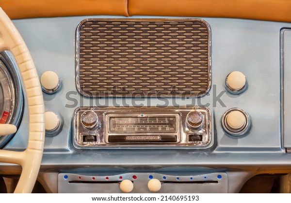 Old chrome car radio with speaker inside a classic\
American car