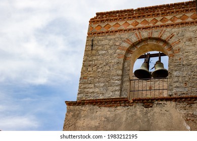 Old Church Bells of a Brick Monastery and blue sky with white clouds