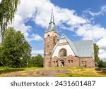 Old church kirk Raislya designed by architect Joseph Stenback in 1912 in style of Finnish national romanticism, northern variety of Art Nouveau in sunny summer day. Melnikovo, Leningrad region. Russia