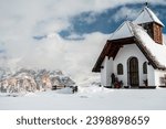 An old church on the top of the mountain in italian alps during winter season