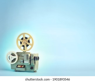 Old cinema projector on blue background