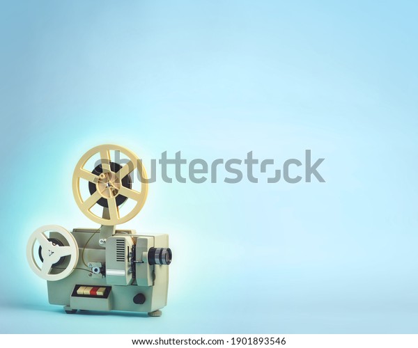 Old cinema projector\
on blue background