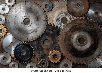 Old circular saw blades and emery wheels on wooden table, close up, top view. Carpentry tools, sawing and grinding equipment - Powered by Shutterstock