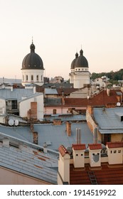 Old City Buildings. View Of The City From A Height. Sunset Over The City. Warm Colors. The Photo Is Vertical, Color.