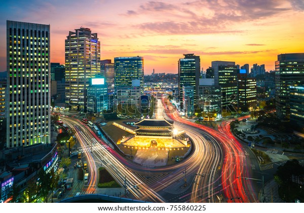 Old city gate in seoul city eith sunset\
and light from traffic and car, South Korea,\
Asia