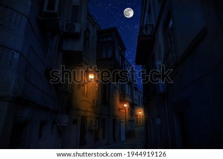 Old city streets at night. Full moon over the city at night, Baku Azerbaijan. Big full moon shining bright over buildings