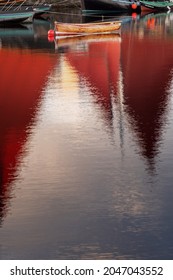 Old Classic Brown Color Varnished Fishing Boat In A River. Old Boat With Red Sail Reflection In Water. Galway City, Ireland. Fine Example Of Old Craft In Show Room Condition.