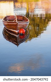 Old Classic Brown Color Varnished Fishing Boat In A River. Fine Example Of Old Craft In Show Room Condition. History And Heritage Concept