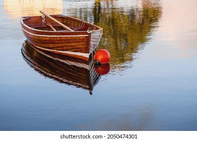 Old Classic Brown Color Varnished Fishing Boat In A River. Fine Example Of Old Craft In Show Room Condition. History And Heritage Concept