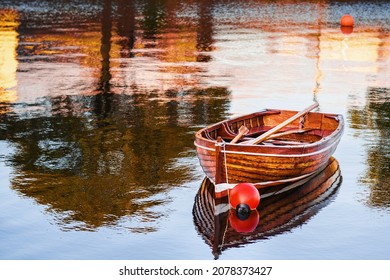 Old Classic Brown Color Varnished Fishing Boat In A River. Fine Example Of Old Craft In Show Room Condition. History And Heritage Concept