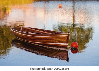 Old Classic Brown Color Varnished Fishing Boat In A River. Fine Example Of Old Craft In Show Room Condition. History And Heritage Concept